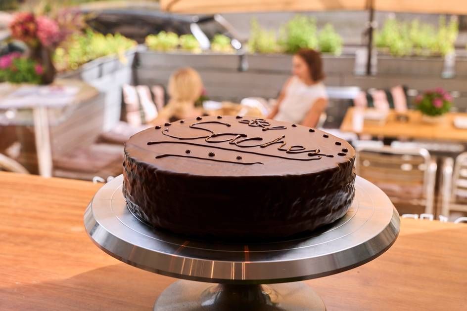 A beautifully presented Sacher Cake, a decadent chocolate treat, resting on a table, perfect for any celebration.