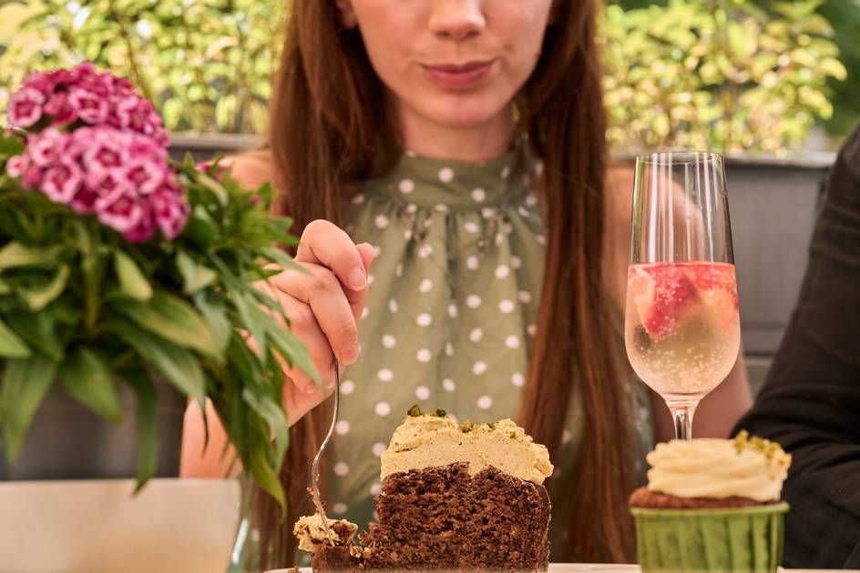 A lady enjoying desserts, landscape view.