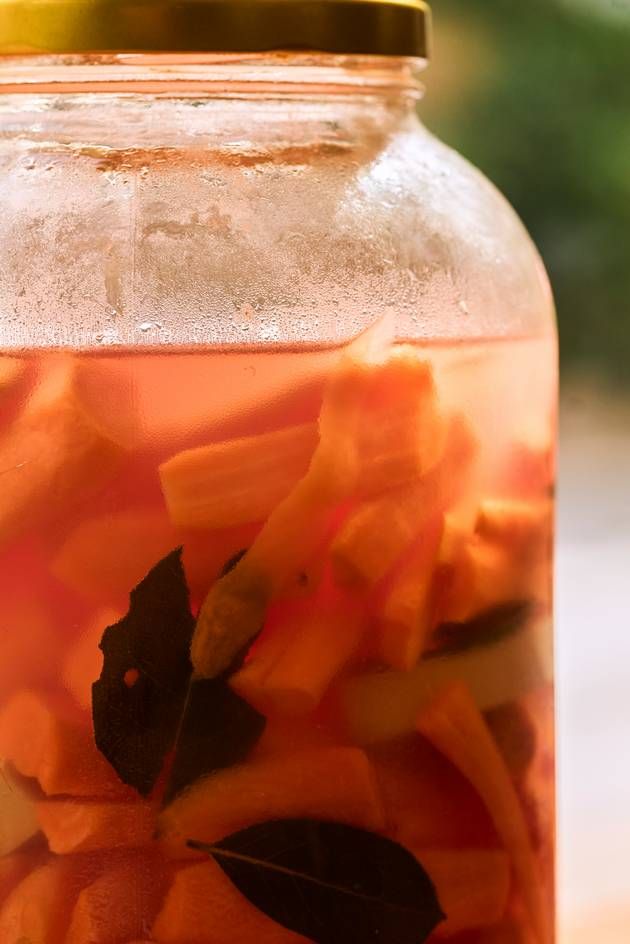 A jar containing a delightful blend of vegetables and herbs, emphasizing the art of fermentation.