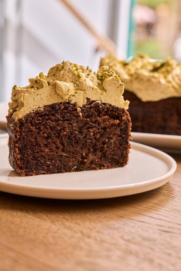 A slice of vegan banana bread drizzled with pistachio ganache, elegantly placed on a plate.