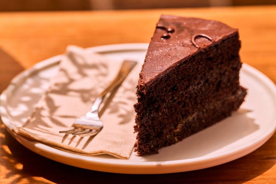 A slice of Sacher Torte on a plate, captured from an angle.