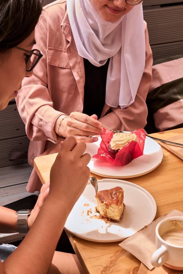 Girls savoring desserts on the café terrace.