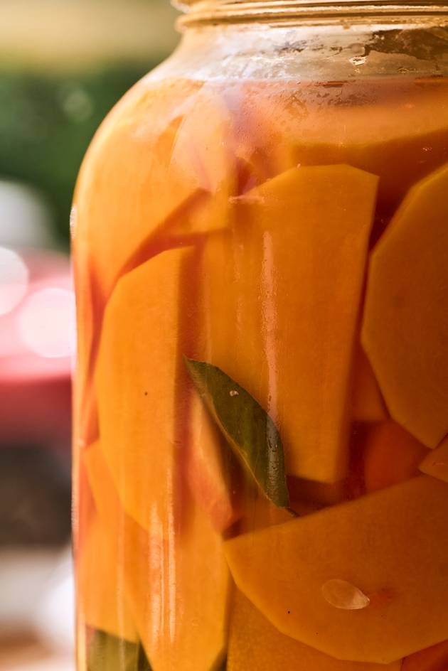 A jar brimming with fermented vegetables rests on a table, highlighting a delightful mix of fvibrant ingredients.